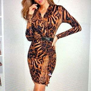 Chic dress with faux leather side belt. Never worn.